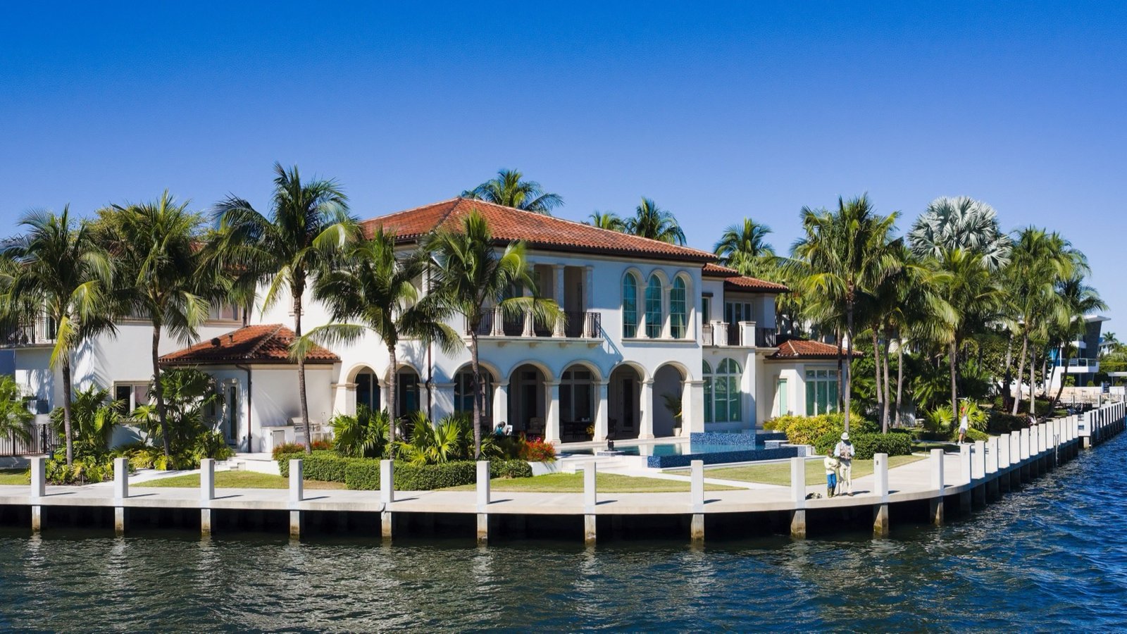 Mediterranean-style waterfront mansion with pool